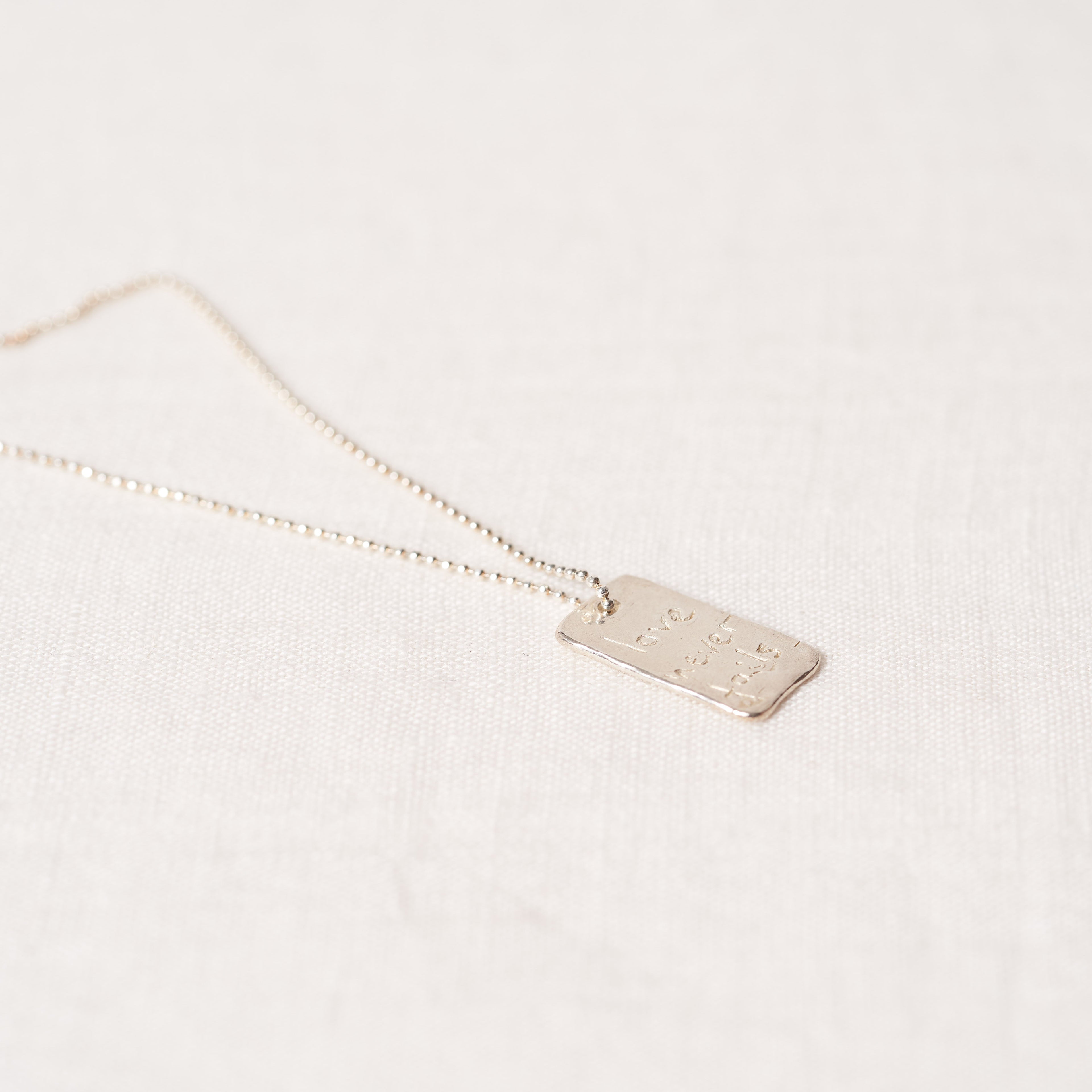 Love never fails necklace