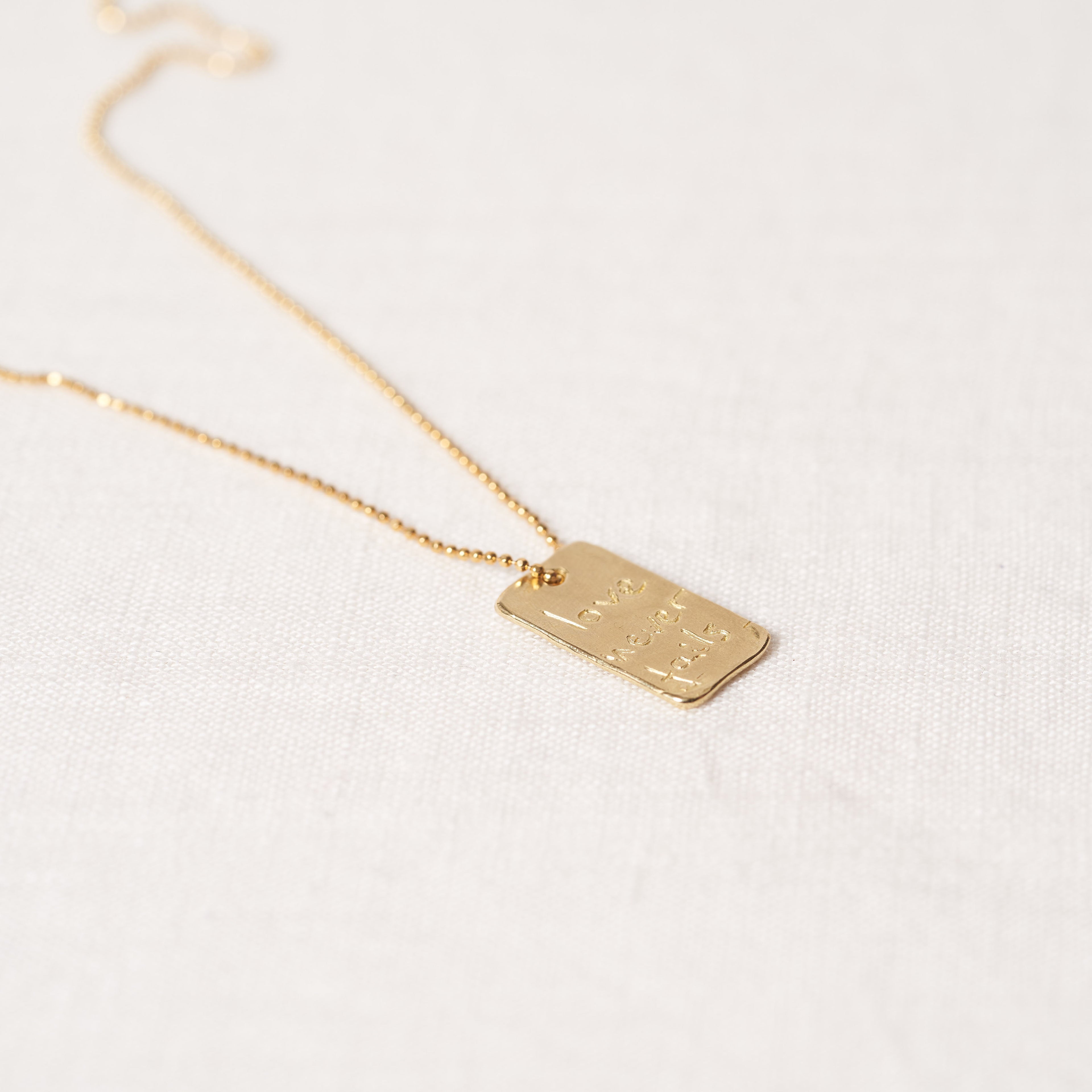 Love never fails necklace